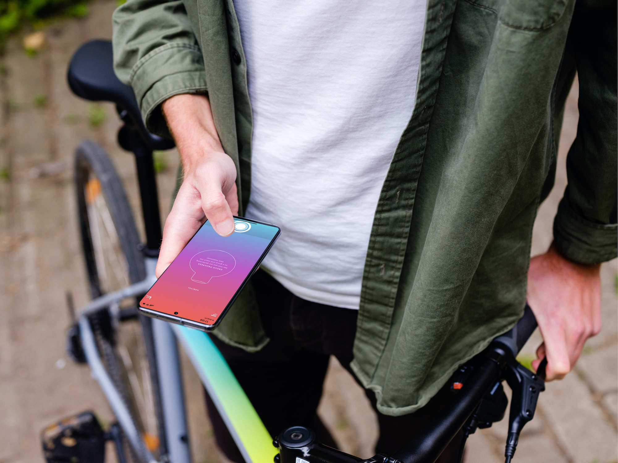 Holding Samsung S20 mockup in front of a bike (Mockuuups Studio)